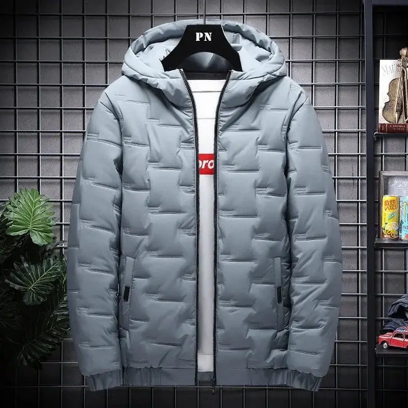 Light gray men's puffer jacket with hood, displayed on black grid wall.