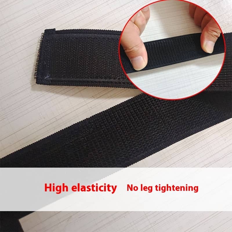 Black elastic band with a close-up of hands stretching it, on a light wooden surface.