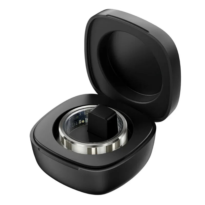 Black smart fitness ring in open black charging case with visible circuit details