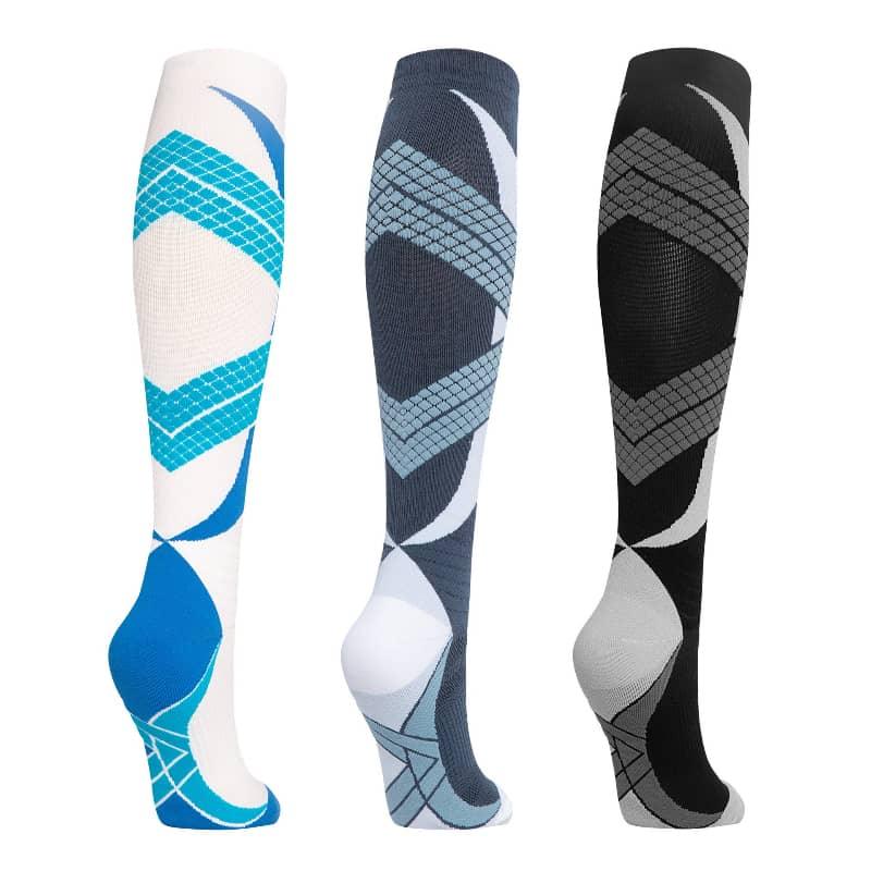 Three pairs of knee-high socks with geometric patterns on a white background