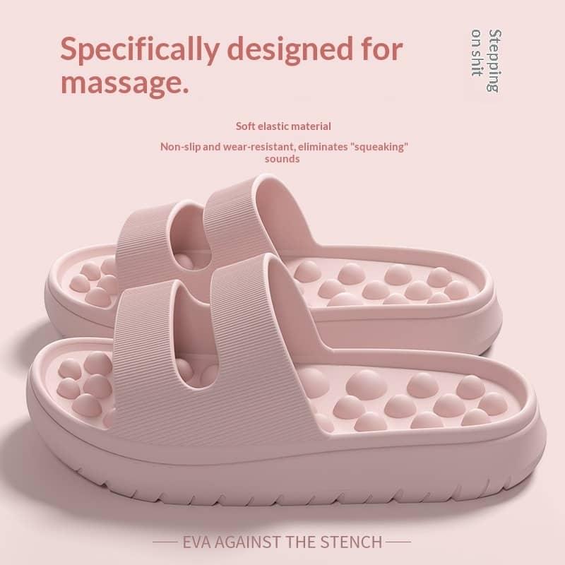 Pink massage slippers with text on a light pink background