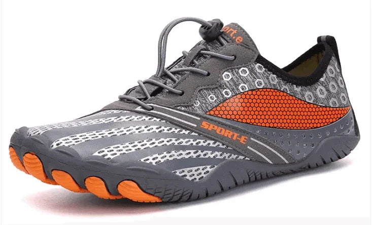 Lightweight gray and orange athletic shoe with breathable mesh and flexible sole.