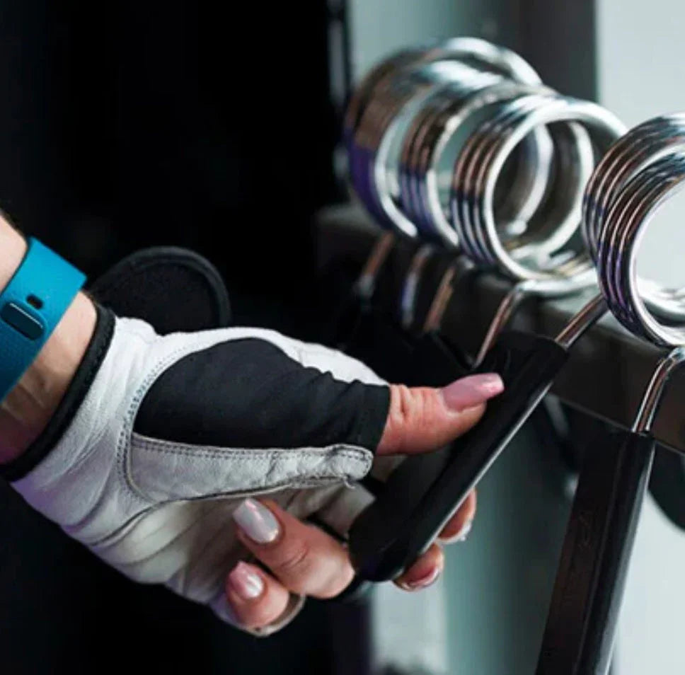 Gloved hand selecting gym clamp from fitness equipment rack