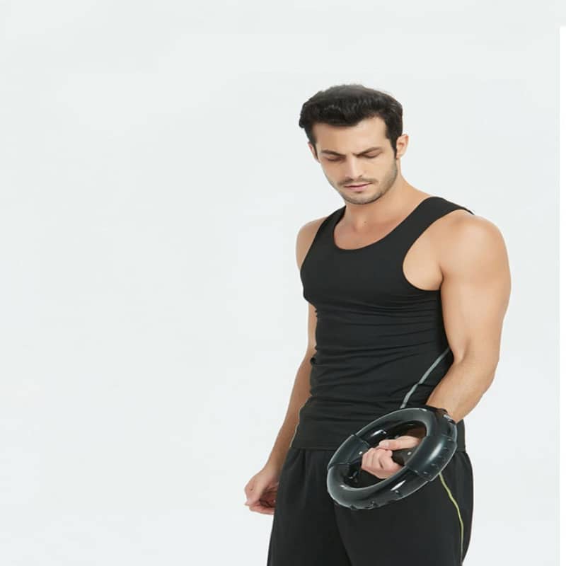Man holding a black weight plate against a white background