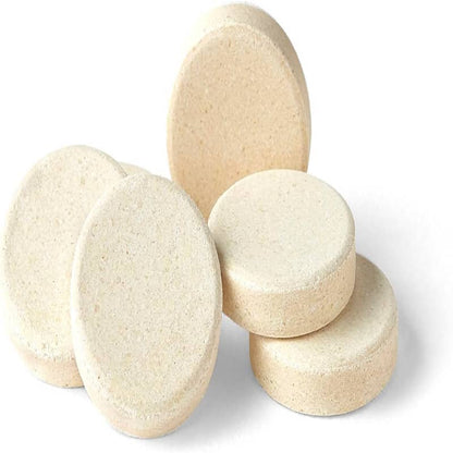 Five round beige supplement tablets stacked on a white background, fitness nutrition