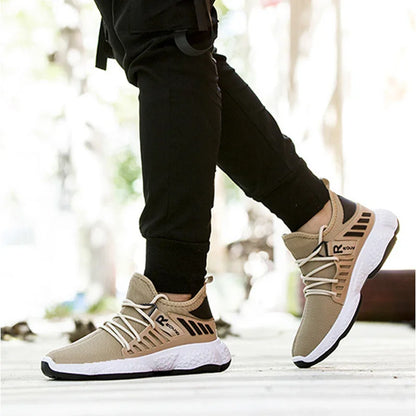 Close-up of person wearing beige and black athletic sneakers with white soles, standing outdoors on pavement