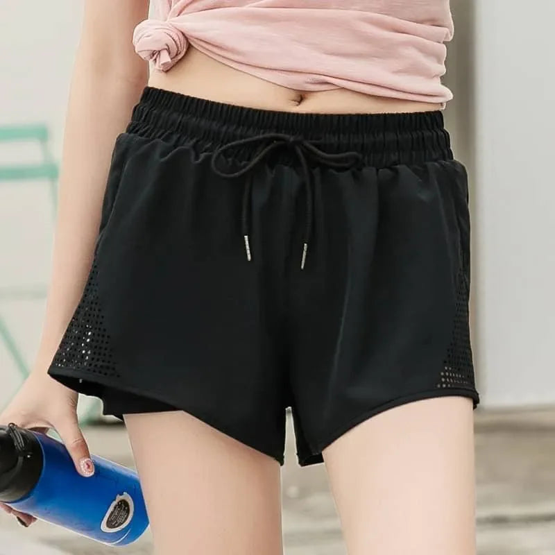 Person wearing black shorts with a blurred background