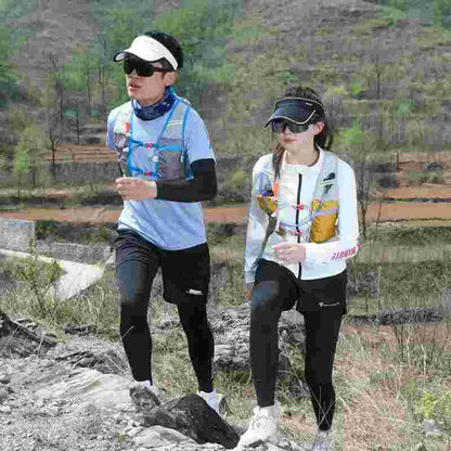 Two people trail running outdoors in sportswear and hydration packs on a rocky path