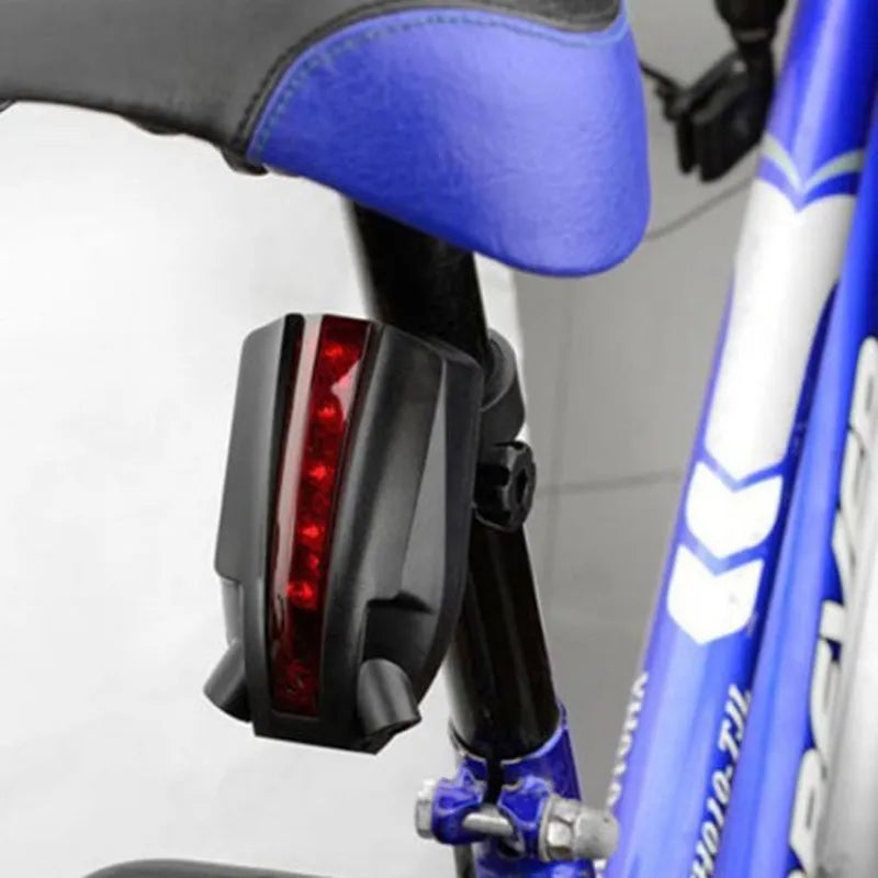 Bicycle tail light attached to a blue bicycle frame.