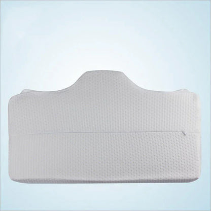 Ergonomic white memory foam pillow for neck and back support on light blue background