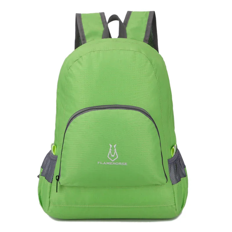 Lightweight green backpack with front zip pocket and side mesh pockets, outdoor gear.