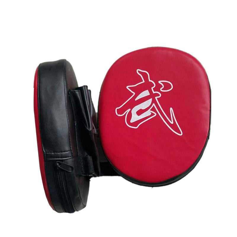 Red and black martial arts training pads with a white symbol on a white background