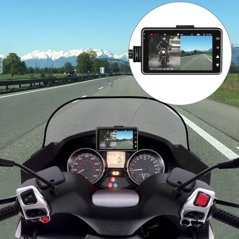 Motorcycle dashboard with multiple screens displaying a road ahead, mountains, and a video feed.