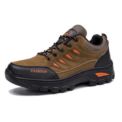 Brown trekking shoe with black sole, orange accents, and rugged outdoor design