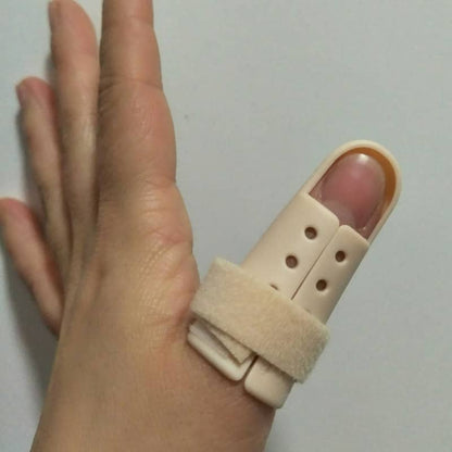 Hand wearing a beige finger splint on a plain background