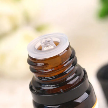 Close-up of a brown glass bottle with a white cap on a blurred background