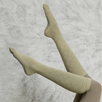 Beige knee-high compression socks with textured grip soles against a light background