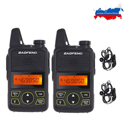 Two black Baofeng walkie-talkies with earbuds on a white background