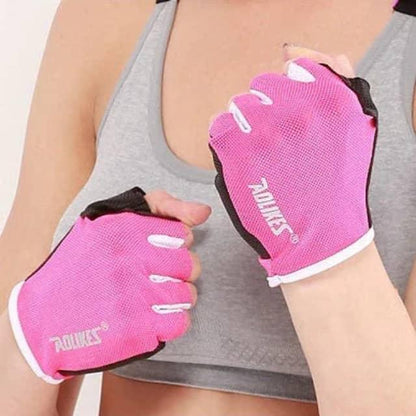 Woman wearing pink fitness gloves and a grey sports bra, ready for workout or weightlifting