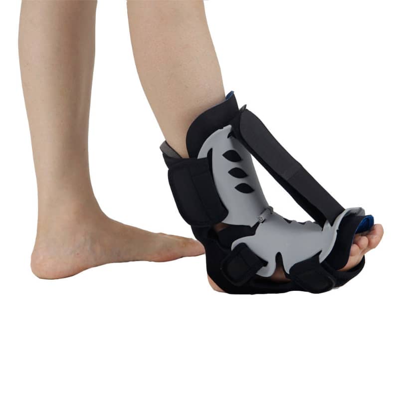 Person wearing adjustable ankle and foot brace for injury support and recovery