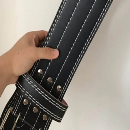 Hand holding a black leather weightlifting belt with white stitching and metal rivets