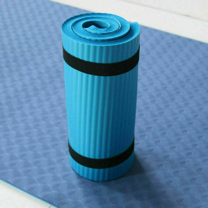 Blue yoga mat with black bands on a blue textured surface