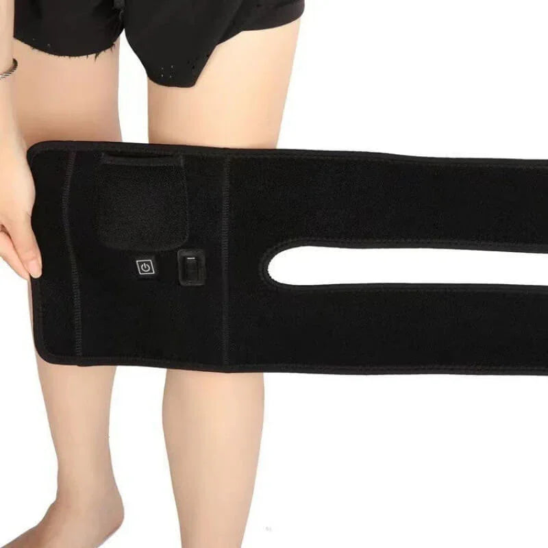Person holding black adjustable knee brace with control buttons for fitness recovery