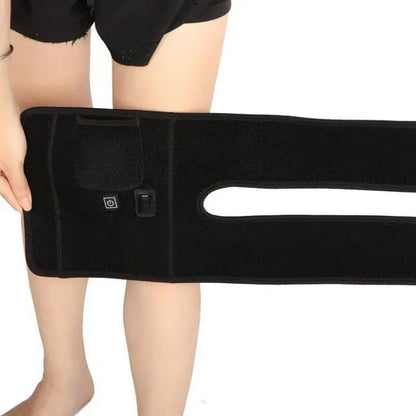 Person holding black adjustable knee brace with control buttons for fitness recovery