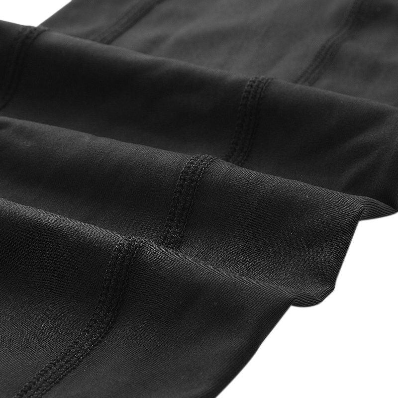 Close-up of black athletic fabric with detailed stitching, premium workout apparel textile