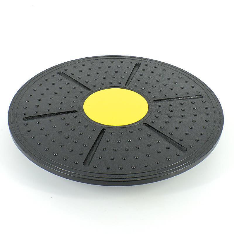 Black exercise disc with a yellow center on a white background