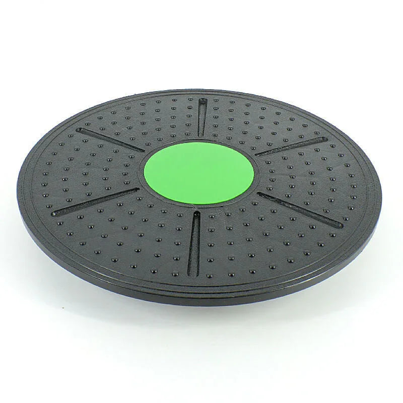 Black exercise disc with a green center on a white background