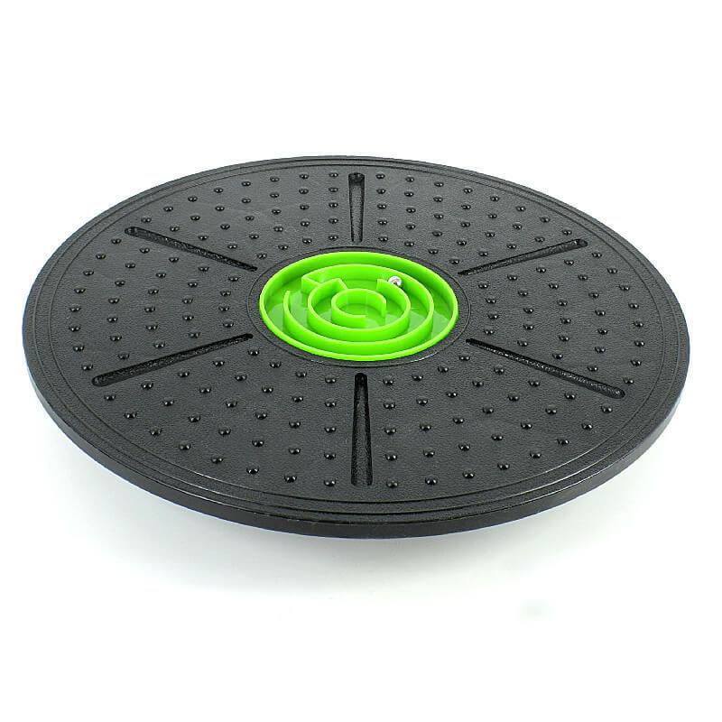 Black exercise disc with a green center on a white background
