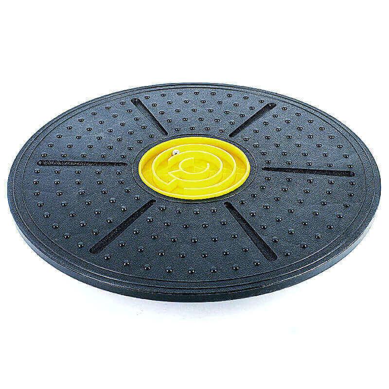 Black balance board with yellow center on a white background