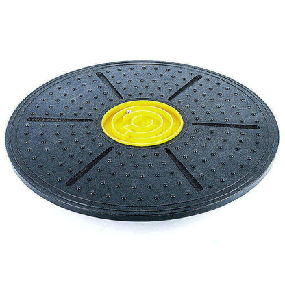 Black balance board with yellow center on a white background