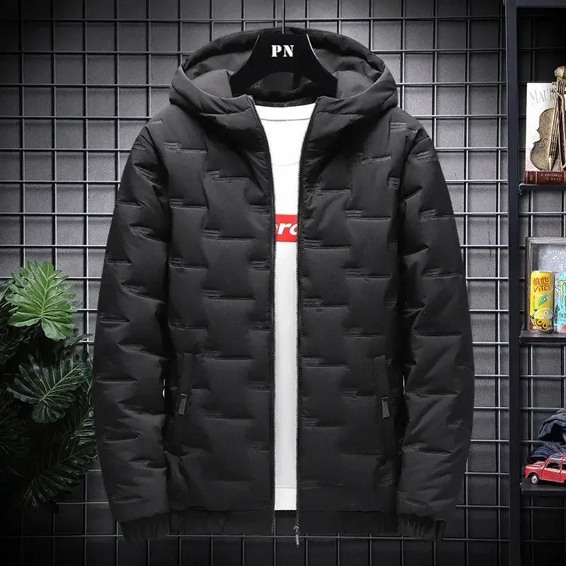 Black puffer jacket with hood and side pockets displayed on a hanger against grid wall