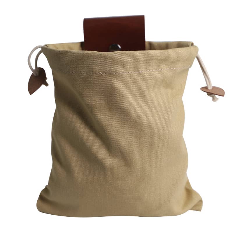 Beige drawstring bag with a brown leather card on a white background