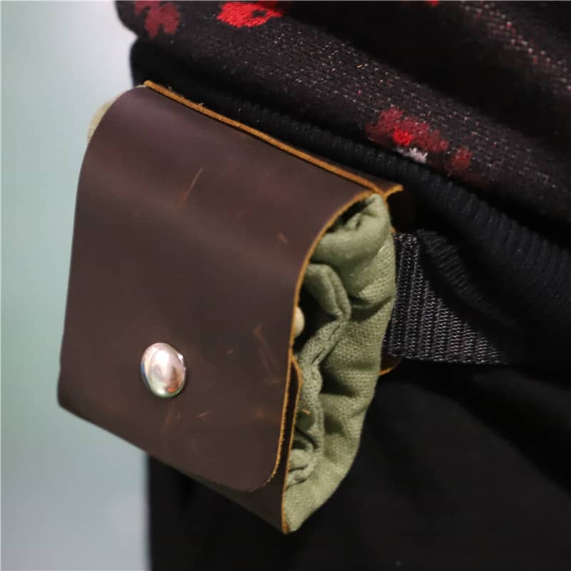 Close-up of a brown leather patch with a button on a garment.
