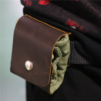 Close-up of a brown leather patch with a button on a garment.