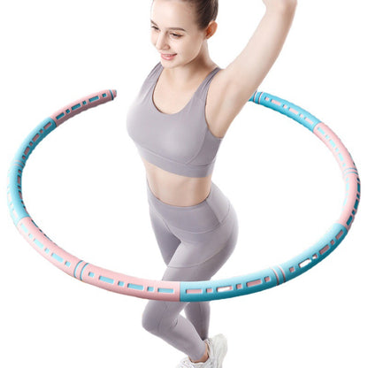 Woman exercising with a pink and blue hula hoop on a white background