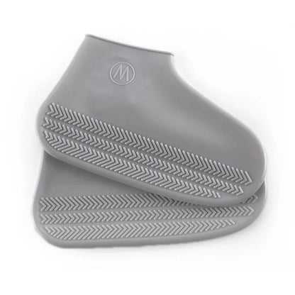 Gray silicone shoe covers with textured sole on a white background