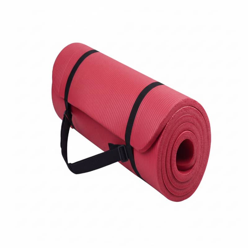 Red yoga mat with a black carrying strap on a white background