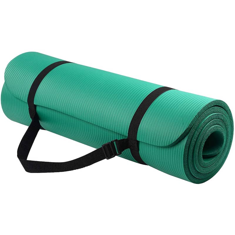Green yoga mat with a black strap on a white background