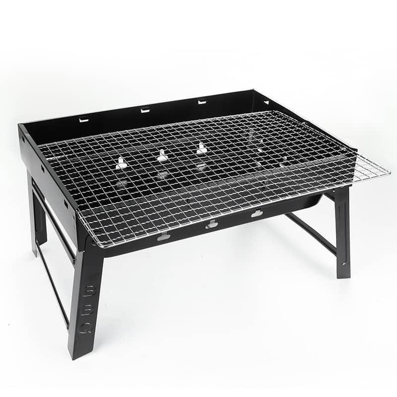 Portable outdoor charcoal grill with folding legs and metal cooking grate