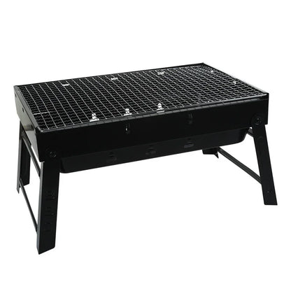 Portable black outdoor charcoal grill with foldable legs and metal grate