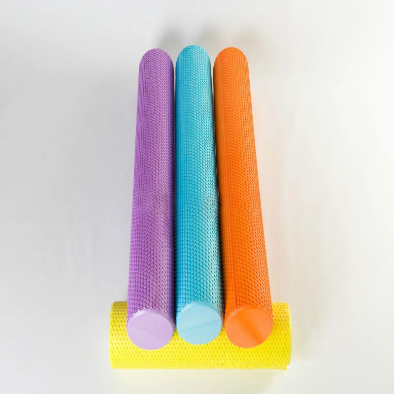 Colorful textured foam rollers for fitness and muscle therapy on a white background