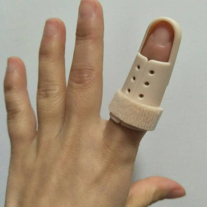 Hand wearing a beige finger splint on a plain background