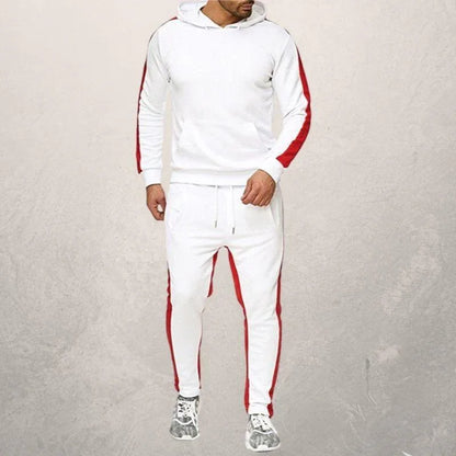 Man wearing white fitness hoodie and joggers with red stripes, styled for athletic workouts