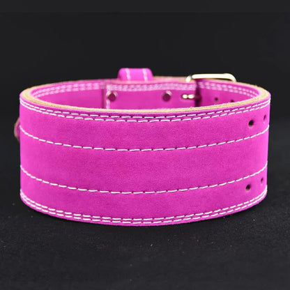 Pink suede weightlifting belt with reinforced stitching on a black background