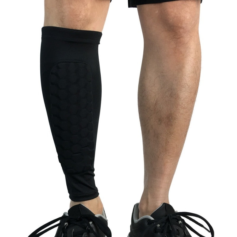 Black leg sleeve on a person's leg against a white background
