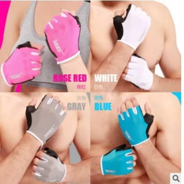 Assorted gym workout gloves in rose red, white, gray, and blue on muscular arms